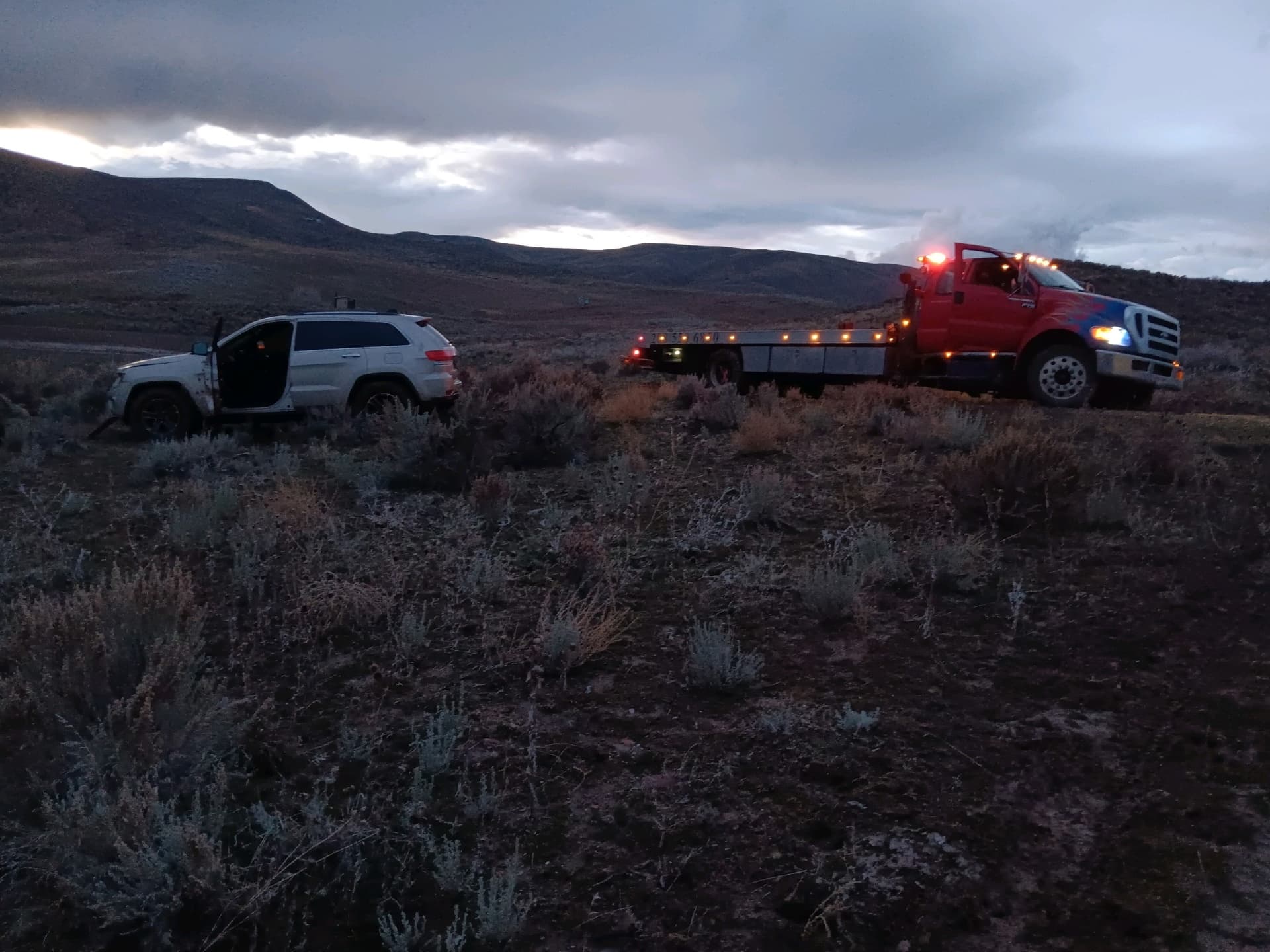 Night off-road recovery with Weiser truck rescuing stranded SUV