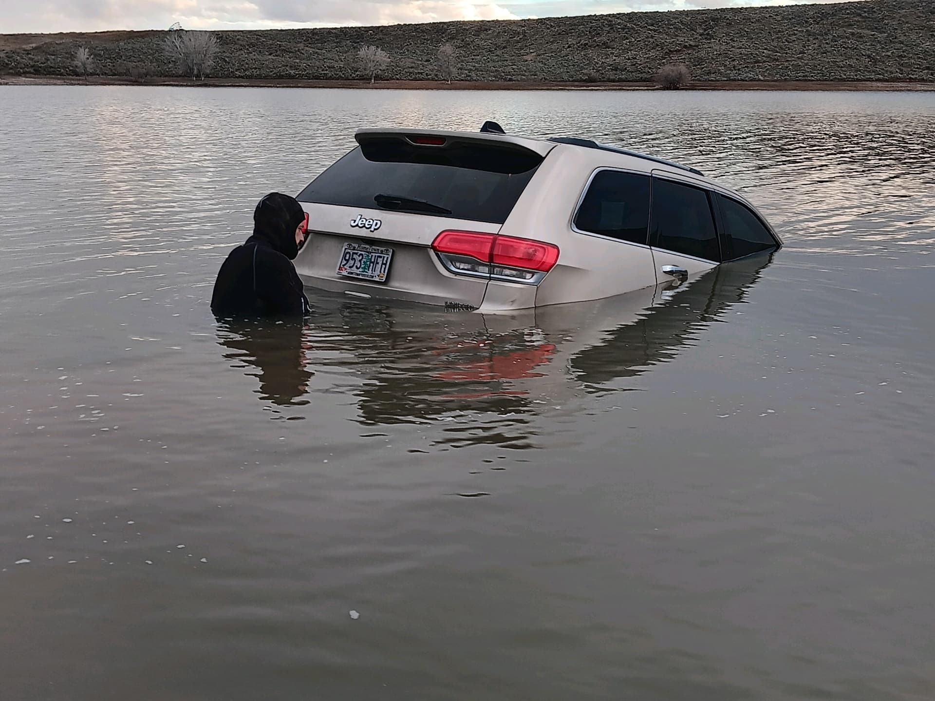 Underwater vehicle recovery - Jeep in water with technician