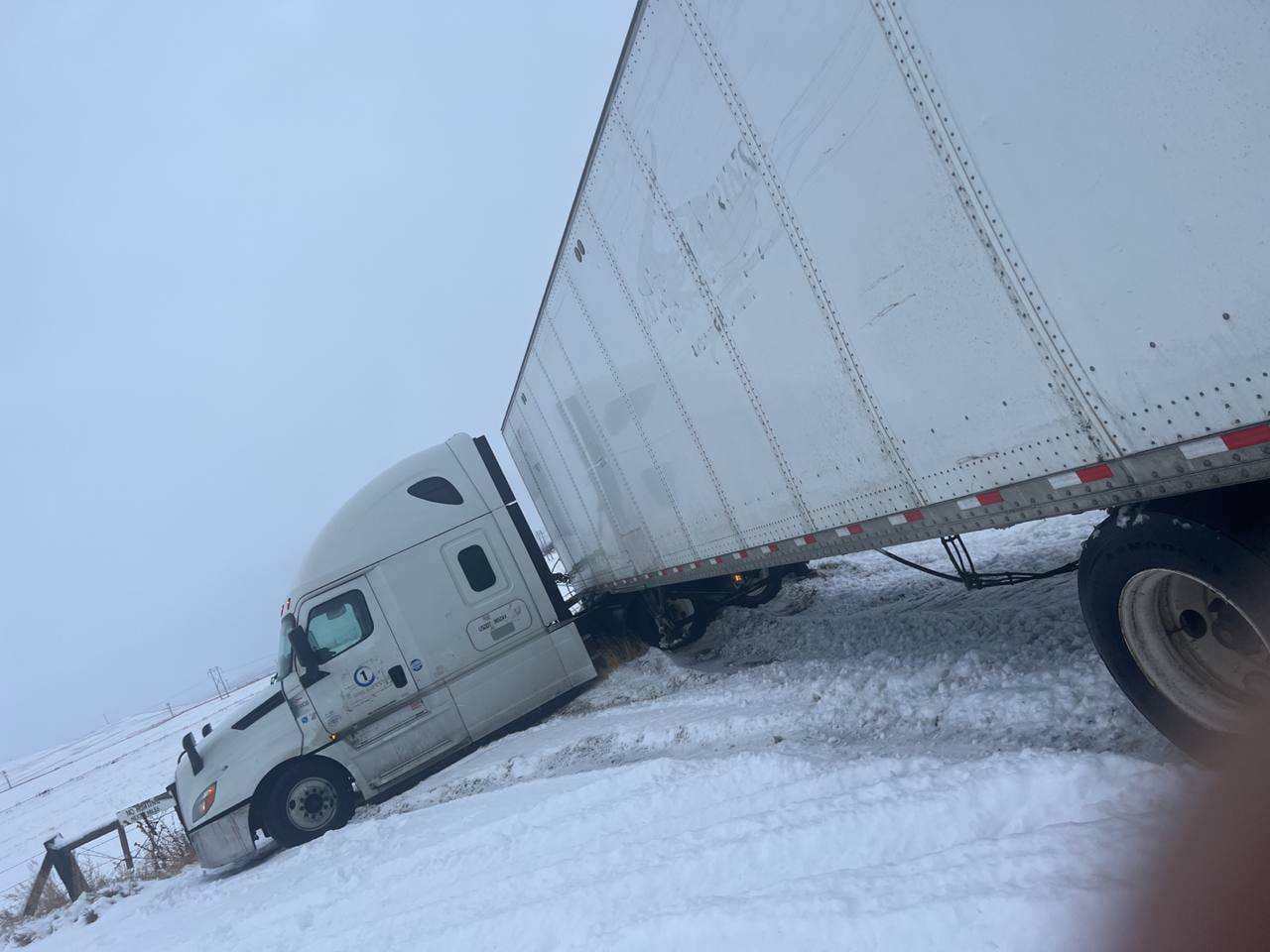 Winter semi-truck jackknife recovery in snow